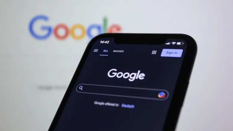 Smartphone in dark mode showing the Google search screen