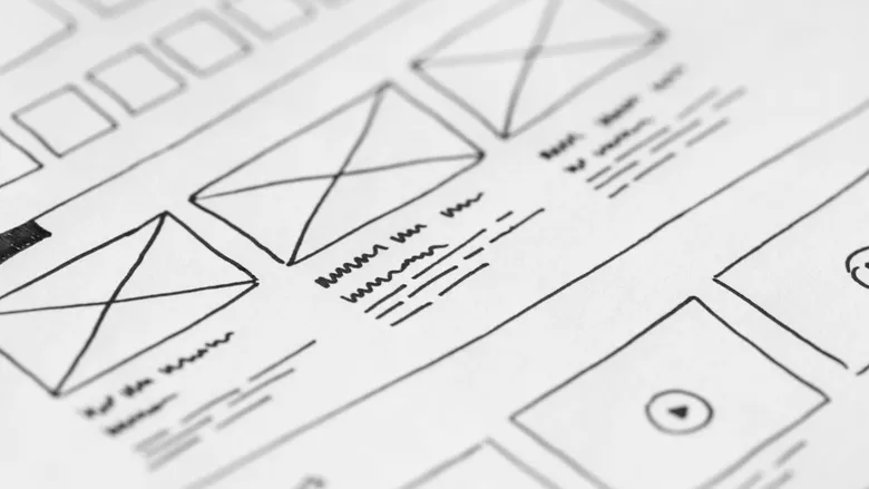 Hand-drawn website wireframe sketched on white paper